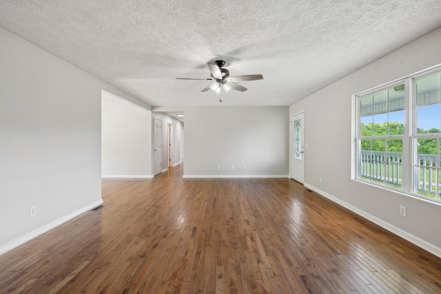 spare room featuring ceiling fan, hardwood / wood-style floors, a textured ceiling, and baseboards