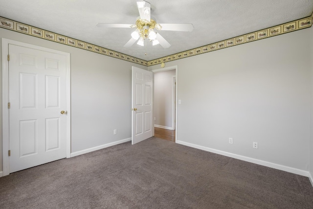 unfurnished bedroom with carpet floors, baseboards, and a ceiling fan