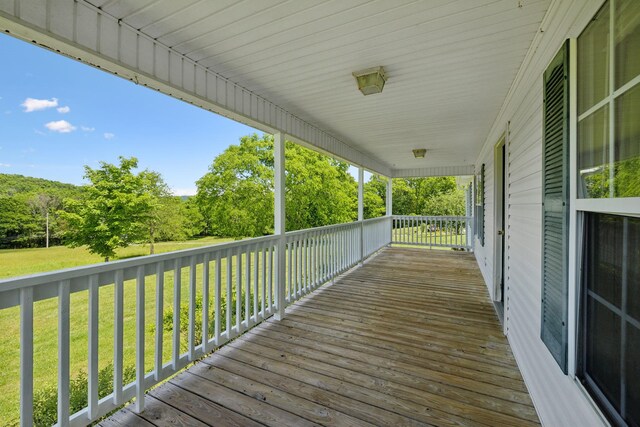 deck featuring a yard and a porch