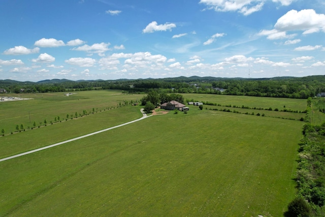 aerial view of sparsely populated area with mountains and a pastoral area