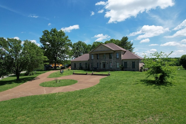view of front of property featuring a front yard and stone siding