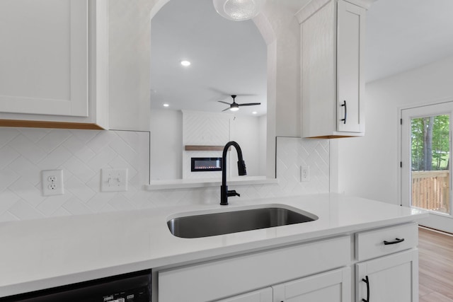 2214 S Hinton Rd, Southside, TN 37171 - kitchen featuring arched walkways, dishwasher, a sink, light countertops, and white cabinets