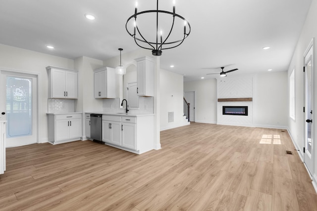 2214 S Hinton Rd, Southside, TN 37171 - kitchen with stainless steel dishwasher, light countertops, a sink, ceiling fan, and a glass covered fireplace