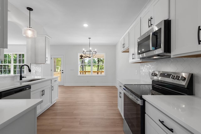 2214 S Hinton Rd, Southside, TN 37171 - kitchen featuring stainless steel appliances, a sink, light countertops, white cabinetry, and recessed lighting