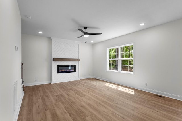 2214 S Hinton Rd, Southside, TN 37171 - unfurnished living room featuring a ceiling fan, light wood-type flooring, a fireplace, baseboards, and recessed lighting