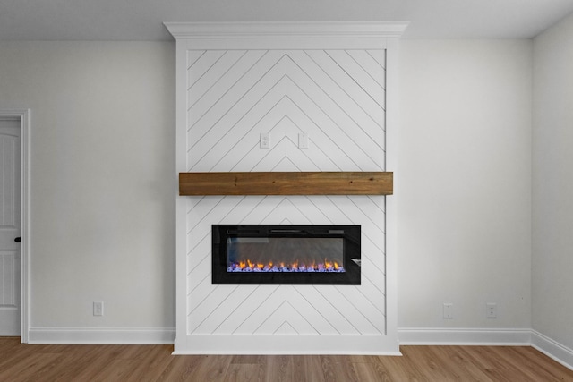2214 S Hinton Rd, Southside, TN 37171 - detailed view of wood finished floors, baseboards, and a fireplace