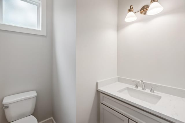 bathroom with toilet and vanity