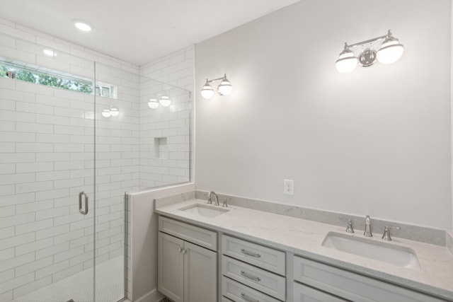 full bathroom featuring a shower stall and double vanity