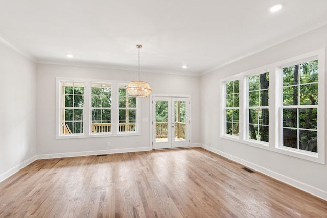 unfurnished dining area with baseboards, a chandelier, light wood-style flooring, recessed lighting, and ornamental molding
