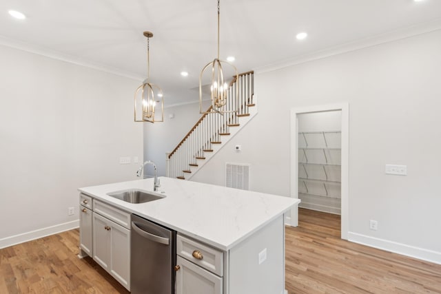 kitchen with a sink, dishwasher, ornamental molding, light wood-style flooring, and a chandelier