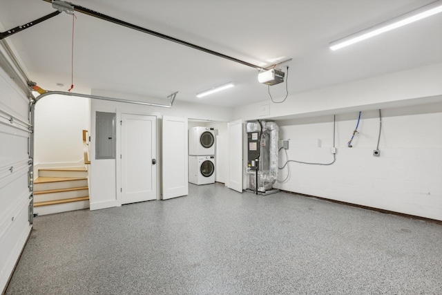 98 N 8th St, Nashville, TN 37206 - garage with stacked washer and clothes dryer, electric panel, a garage door opener, baseboards, and water heater