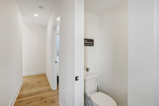 98 N 8th St, Nashville, TN 37206 - bathroom with wood finished floors, toilet, baseboards, and recessed lighting