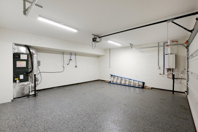 98 N 8th St, Nashville, TN 37206 - garage with a garage door opener, concrete block wall, heating unit, and water heater