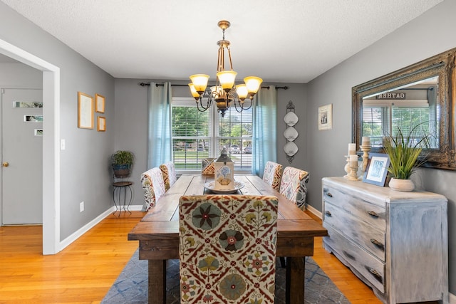 801 Lloyd St, Lawrenceburg, TN 38464 - dining area with a chandelier, light wood-style flooring, baseboards, plenty of natural light, and a textured ceiling