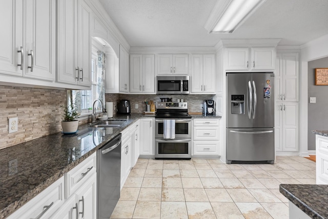 801 Lloyd St, Lawrenceburg, TN 38464 - kitchen featuring stainless steel appliances, a sink, white cabinets, and backsplash