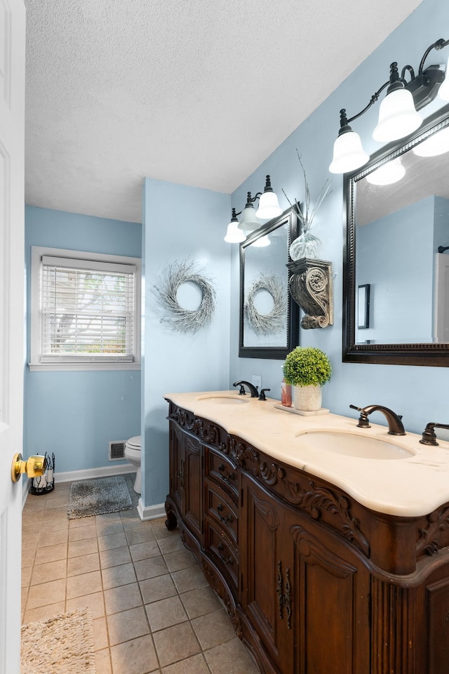 801 Lloyd St, Lawrenceburg, TN 38464 - full bath with a textured ceiling, baseboards, toilet, tile patterned floors, and double vanity