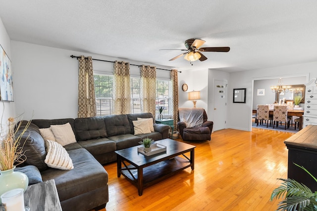 801 Lloyd St, Lawrenceburg, TN 38464 - living room featuring a ceiling fan, light wood-style floors, a chandelier, and a textured ceiling
