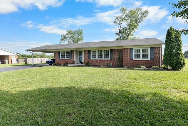 801 Lloyd St, Lawrenceburg, TN 38464 - ranch-style home featuring asphalt driveway, an attached carport, and brick siding