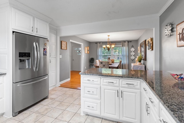 801 Lloyd St, Lawrenceburg, TN 38464 - kitchen featuring stainless steel fridge, light tile patterned flooring, a chandelier, white cabinets, and crown molding