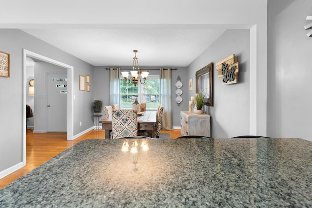 801 Lloyd St, Lawrenceburg, TN 38464 - dining area with a chandelier, light wood-style flooring, and baseboards