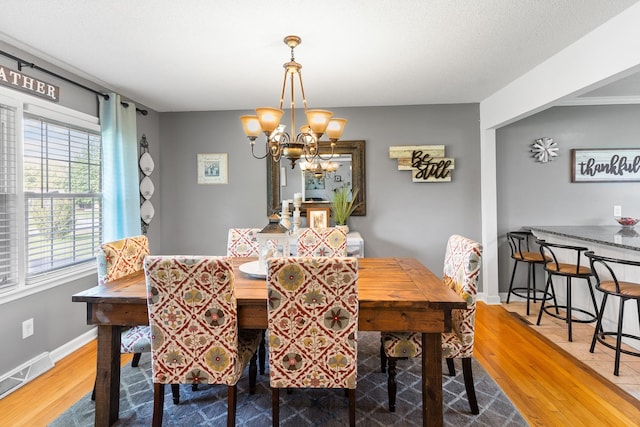 801 Lloyd St, Lawrenceburg, TN 38464 - dining room with wood finished floors, a chandelier, and baseboards