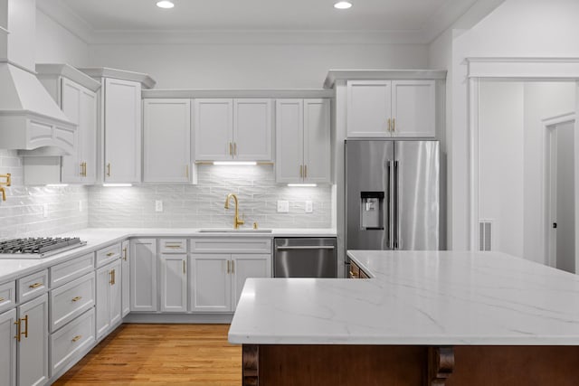 2208 Launcelot Rd, Chattanooga, TN 37421 - kitchen with a sink, appliances with stainless steel finishes, crown molding, white cabinetry, and decorative backsplash