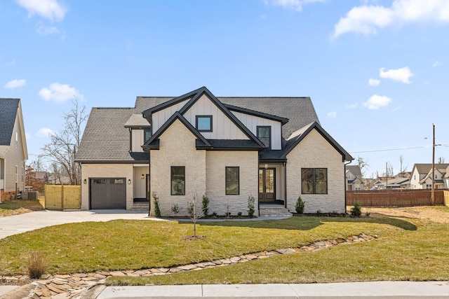 2208 Launcelot Rd, Chattanooga, TN 37421 - view of front facade with concrete driveway, board and batten siding, central AC unit, stone siding, and a shingled roof