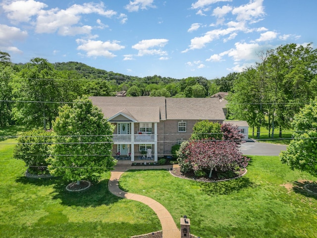 500 Mark Green Ct, Spring Hill, TN 37174 - rear view of house with a balcony, a lawn, a wooded view, and a shingled roof