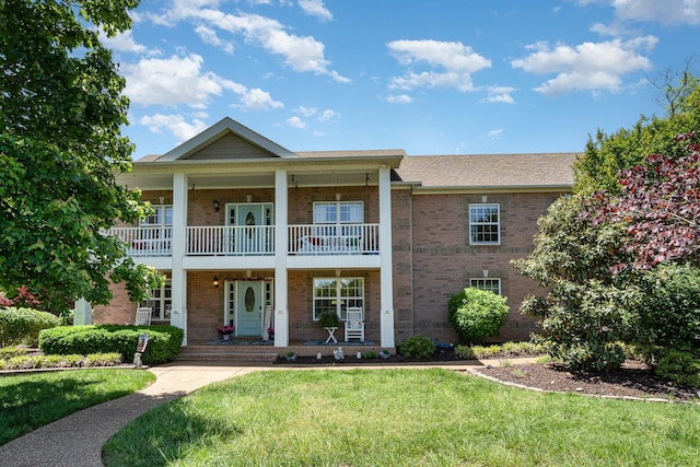 500 Mark Green Ct, Spring Hill, TN 37174 - view of front facade with a porch, a front lawn, brick siding, and a balcony