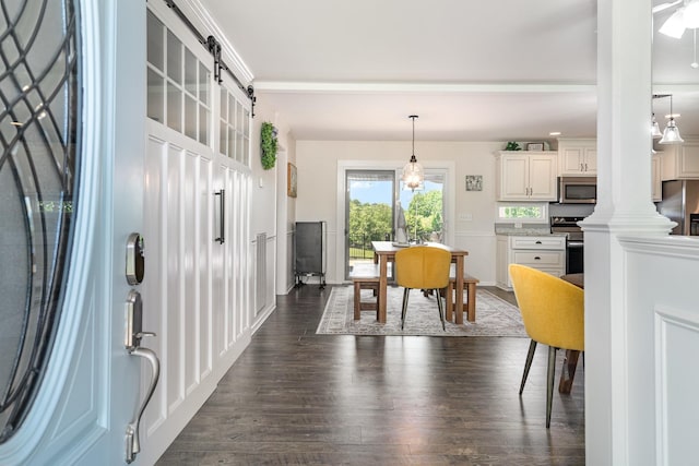 500 Mark Green Ct, Spring Hill, TN 37174 - dining space featuring a barn door, dark wood finished floors, and ornate columns