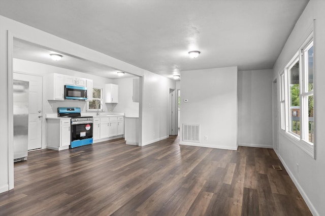97 Baker St, Tracy City, TN 37387 - unfurnished living room featuring dark wood-style flooring, baseboards, and a sink