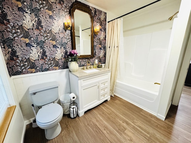215 W College St, Bradford, TN 38316 - full bath featuring wainscoting, wood finished floors, vanity, shower / bathtub combination with curtain, and wallpapered walls