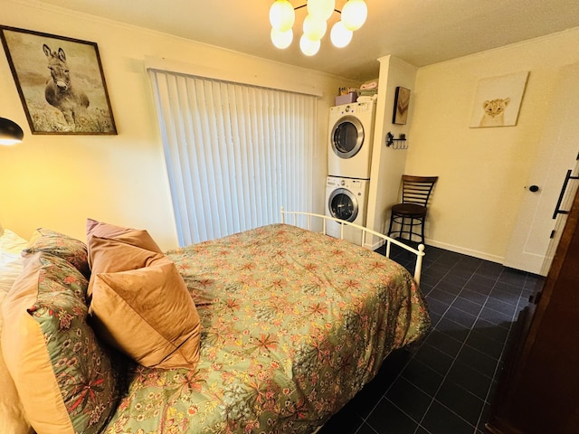 215 W College St, Bradford, TN 38316 - tiled bedroom with stacked washer / dryer, a chandelier, and crown molding