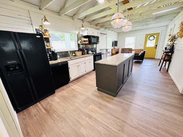 215 W College St, Bradford, TN 38316 - kitchen with black appliances, a chandelier, light wood finished floors, and beam ceiling