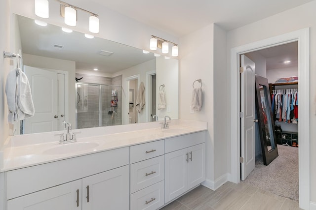 3308 Longstalk Rd, Antioch, TN 37013 - bathroom featuring a stall shower, double vanity, a spacious closet, and baseboards