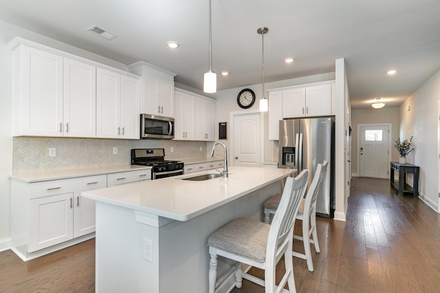 3308 Longstalk Rd, Antioch, TN 37013 - kitchen with appliances with stainless steel finishes, a sink, tasteful backsplash, dark wood-style flooring, and recessed lighting