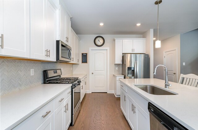 3308 Longstalk Rd, Antioch, TN 37013 - kitchen with stainless steel appliances, a sink, dark wood-style floors, light countertops, and recessed lighting