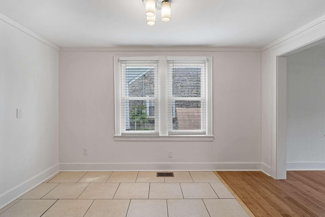 unfurnished room featuring baseboards and light wood-type flooring