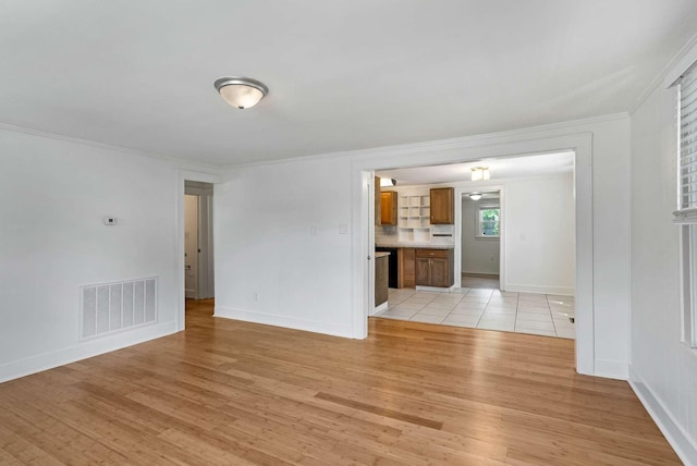 unfurnished living room featuring light wood-style flooring, baseboards, and ornamental molding