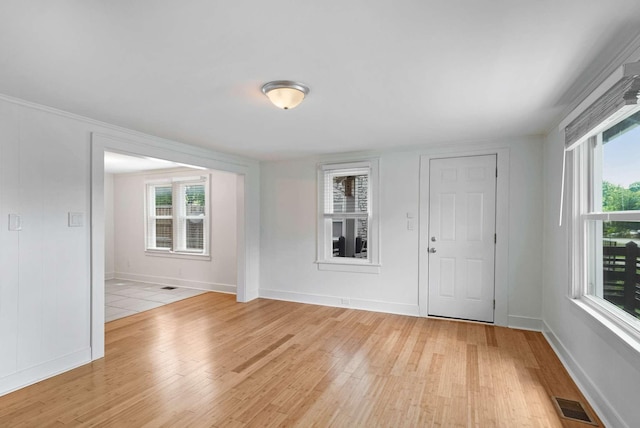 entryway with light wood-style flooring and baseboards