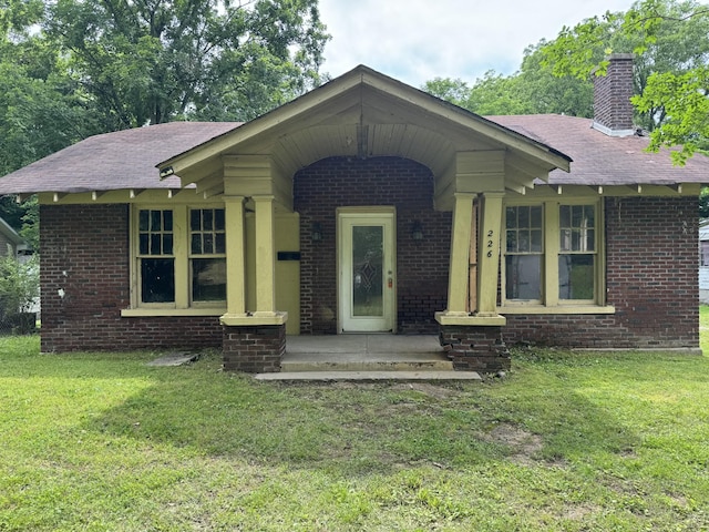 226 Highland St, Ripley, TN 38063 - bungalow-style house with brick siding, a shingled roof, and a front yard