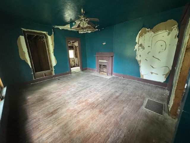 226 Highland St, Ripley, TN 38063 - unfurnished living room featuring ceiling fan, wood finished floors, a fireplace, and baseboards