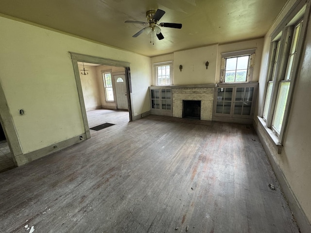 226 Highland St, Ripley, TN 38063 - unfurnished living room featuring wood finished floors, a fireplace, ceiling fan, and baseboards