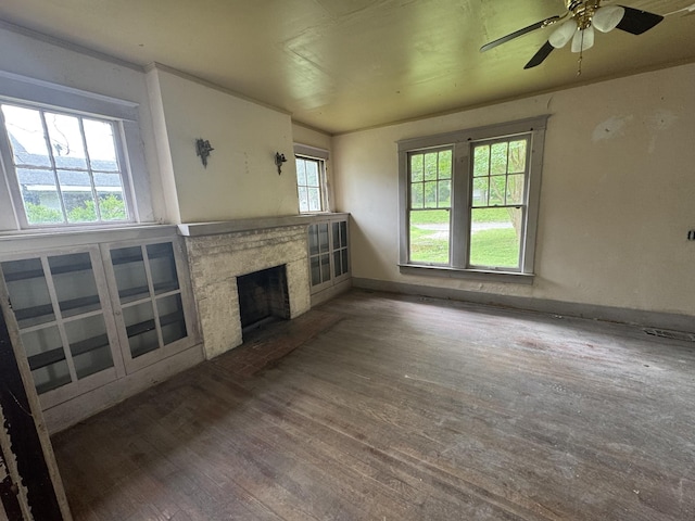 226 Highland St, Ripley, TN 38063 - unfurnished living room featuring wood finished floors, a high end fireplace, a ceiling fan, and baseboards