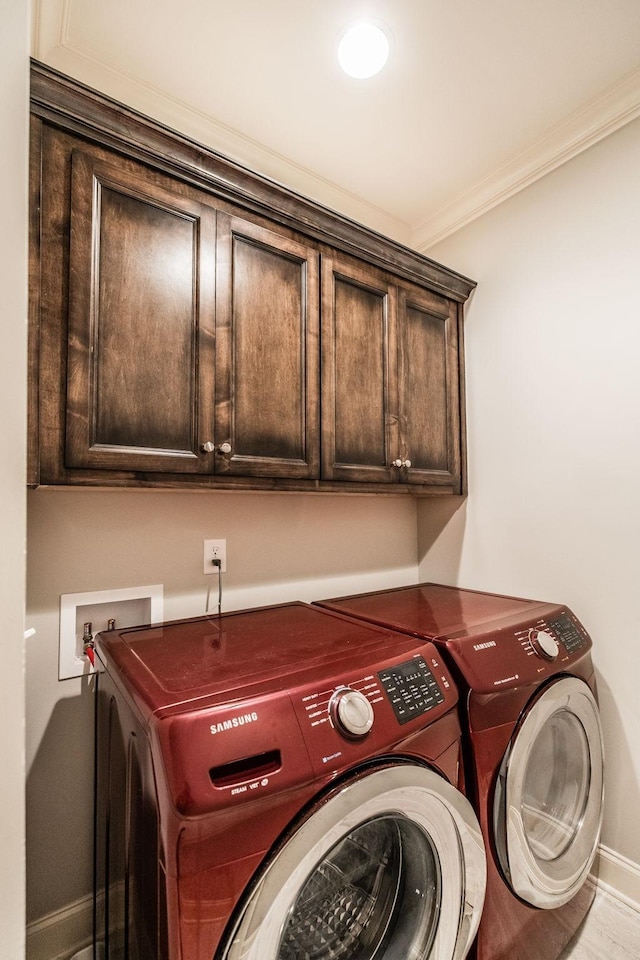 1219 Ben Forkum Dr, Lebanon, TN 37087 - clothes washing area with washer and dryer, cabinet space, baseboards, and ornamental molding