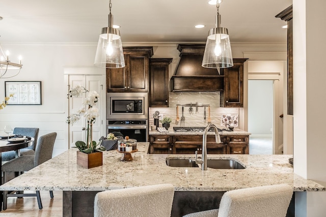 1219 Ben Forkum Dr, Lebanon, TN 37087 - kitchen with stainless steel appliances, a sink, dark brown cabinets, custom range hood, and a kitchen breakfast bar