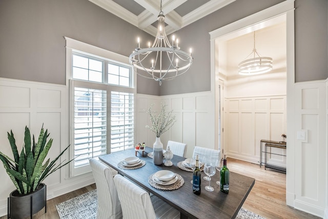 1219 Ben Forkum Dr, Lebanon, TN 37087 - dining space featuring a chandelier, a decorative wall, wainscoting, ornamental molding, and light wood-type flooring