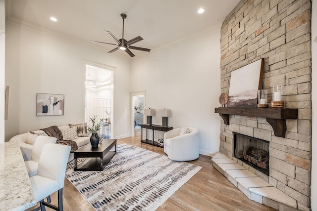 1219 Ben Forkum Dr, Lebanon, TN 37087 - living area with ceiling fan, crown molding, a stone fireplace, wood finished floors, and recessed lighting