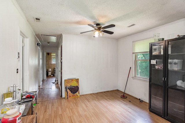 unfurnished room featuring wood finished floors, a textured ceiling, and ceiling fan