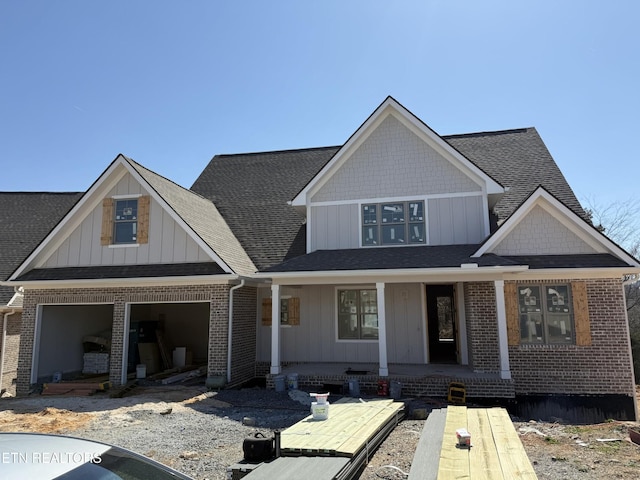 2412 Misty Mountain Cir, Knoxville, TN 37932 - view of front facade featuring brick siding, a porch, and board and batten siding
